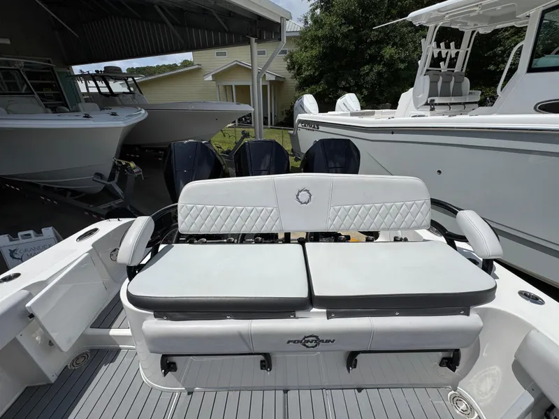 Slide: The Image of 2021 Fountain 38TE boat with cushioned seating and multiple outboard engines in a marina. - 40