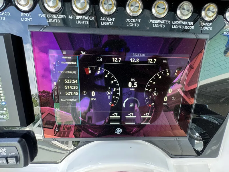 Slide: The Image of Dashboard of a 2021 Fountain 38TE boat displaying engine metrics and light controls. - 43