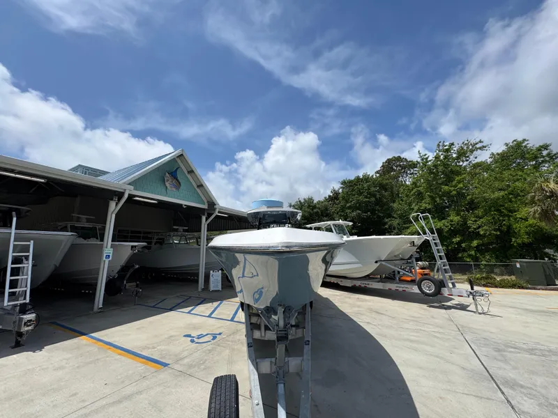 Slide: The Image of 2021 Fountain 38TE boat on trailer in sunny outdoor storage area. - 7