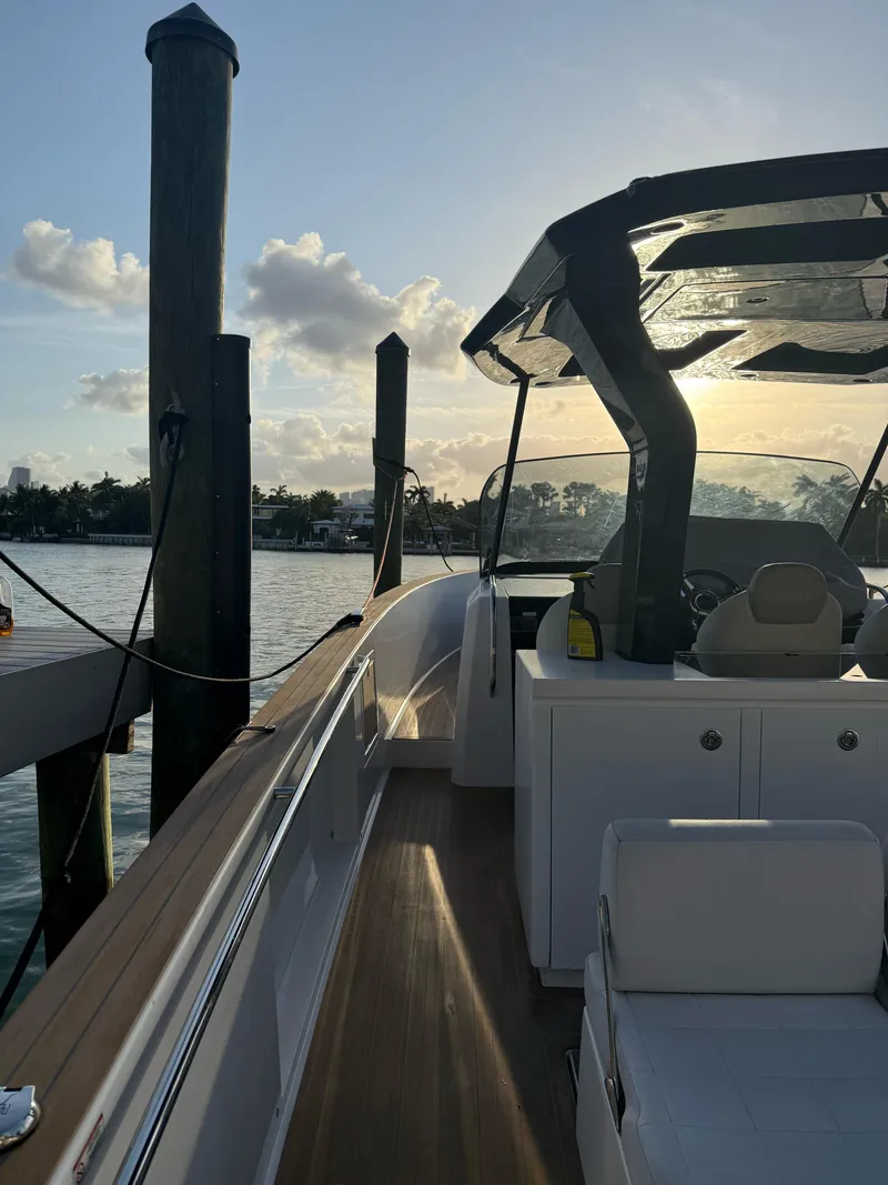 Slide: The Image of 2022 Pardo Yachts 38 docked at sunset, showcasing sleek design and luxury features. - 2