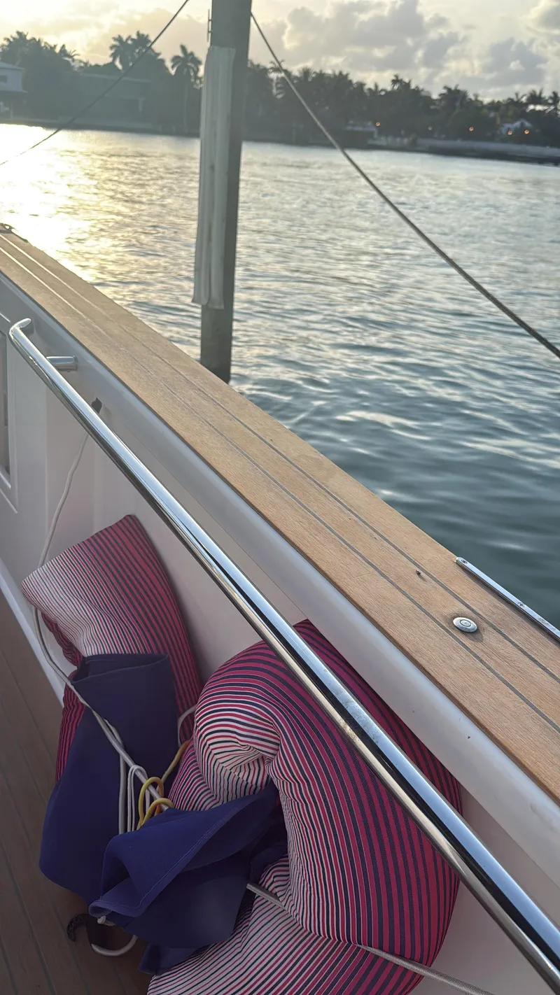Slide: The Image of 2022 Pardo Yachts 38 deck with cushions, overlooking serene water at sunset. - 6