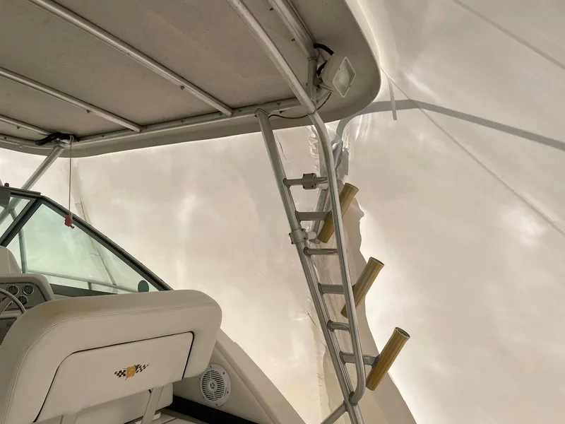 Slide: The Image of Interior view of a 2000 Wellcraft 330 Coastal boat, featuring seating and a ladder. - 10