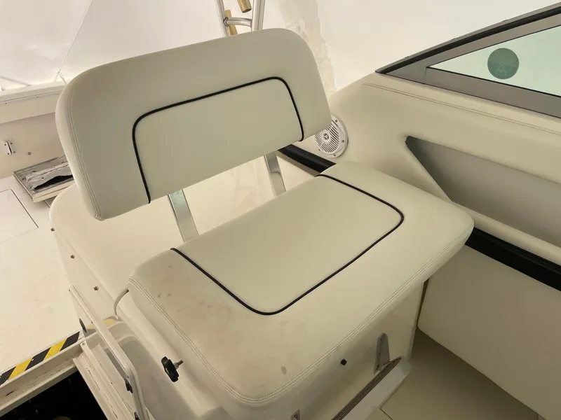 Slide: The Image of White seat on 2000 Wellcraft 330 Coastal boat, featuring black trim and modern design. - 11