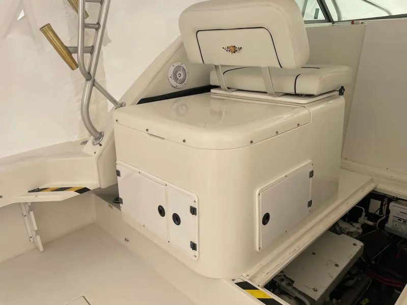 Slide: The Image of 2000 Wellcraft 330 Coastal boat interior with seating and storage compartments. - 12