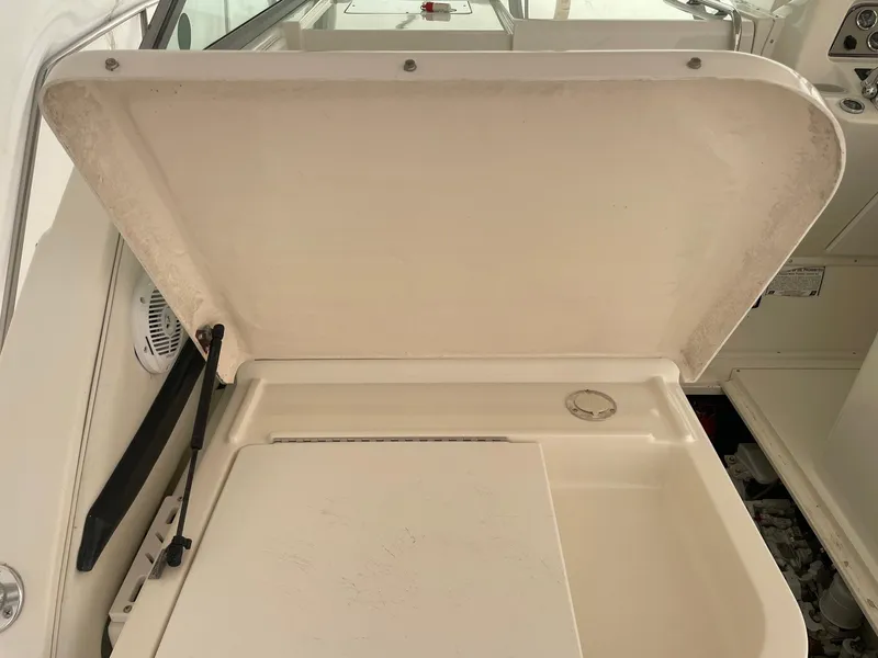 Slide: The Image of Open storage compartment on a 2000 Wellcraft 330 Coastal boat. - 13