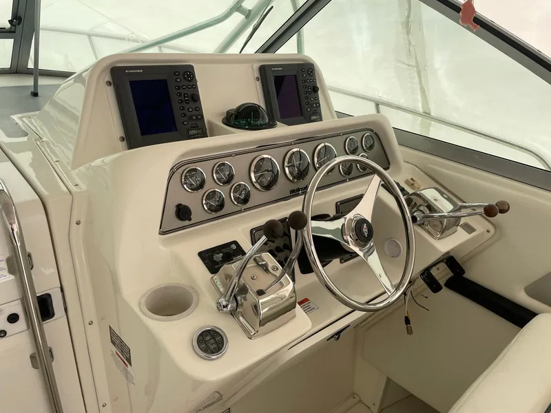 Slide: The Image of Control panel of 2000 Wellcraft 330 Coastal boat with steering wheel and navigation instruments. - 14