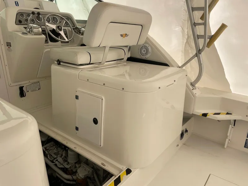 Slide: The Image of 2000 Wellcraft 330 Coastal boat interior with helm and seating area. - 17