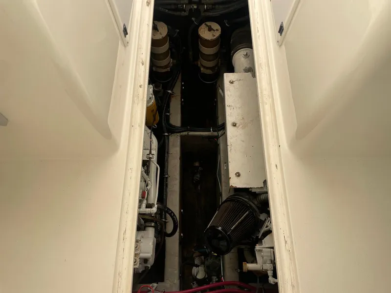 Slide: The Image of Engine compartment of a 2000 Wellcraft 330 Coastal boat, showcasing mechanical components. - 18