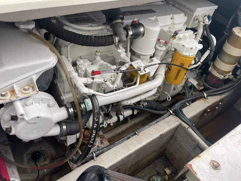 Slide: The Image of Engine compartment of a 2000 Wellcraft 330 Coastal boat, showcasing mechanical components. - 19
