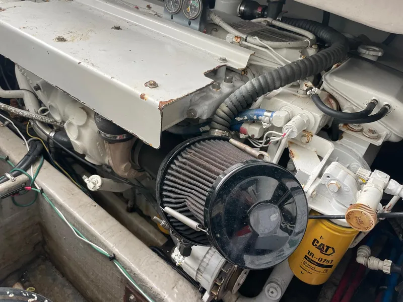 Slide: The Image of Engine compartment of a 2000 Wellcraft 330 Coastal boat, featuring visible components and wiring. - 20