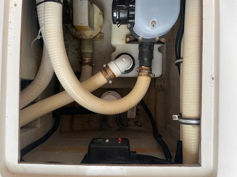 Slide: The Image of Engine compartment of a 2000 Wellcraft 330 Coastal boat, showing hoses and mechanical components. - 23