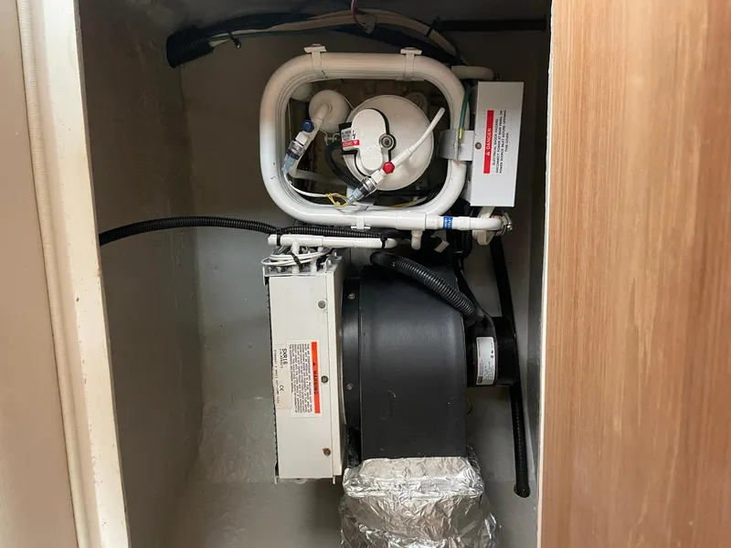 Slide: The Image of Engine compartment of a 2000 Wellcraft 330 Coastal boat, showcasing mechanical components. - 24