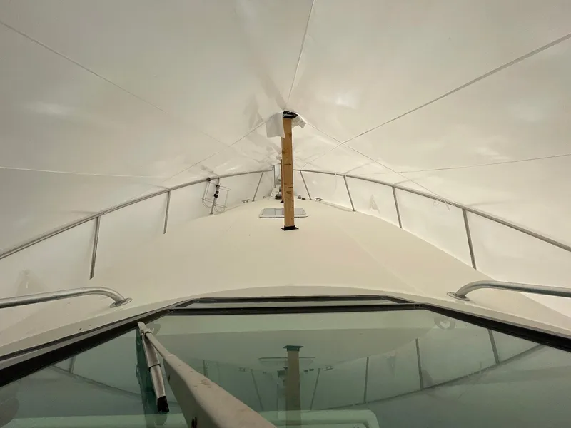 Slide: The Image of Front view of a 2000 Wellcraft 330 Coastal boat under a canopy. - 8