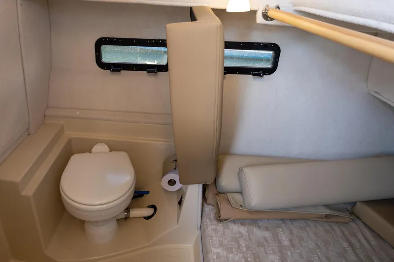 Slide: The Image of 2023 Ranger Tugs R-31 S interior cabin with toilet and seating area. - 11