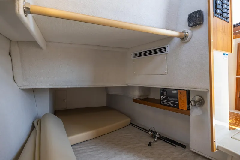 Slide: The Image of 2023 Ranger Tugs R-31 S interior cabin with storage and seating area. - 12