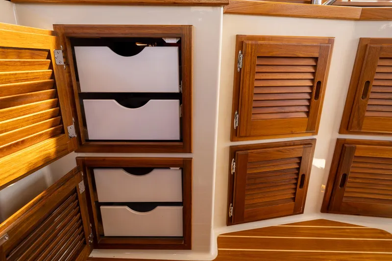 Slide: The Image of 2023 Ranger Tugs R-31 S interior with wooden cabinets and drawers. - 15