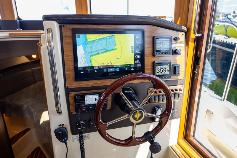Slide: The Image of 2023 Ranger Tugs R-31 S helm with navigation display and controls. - 23