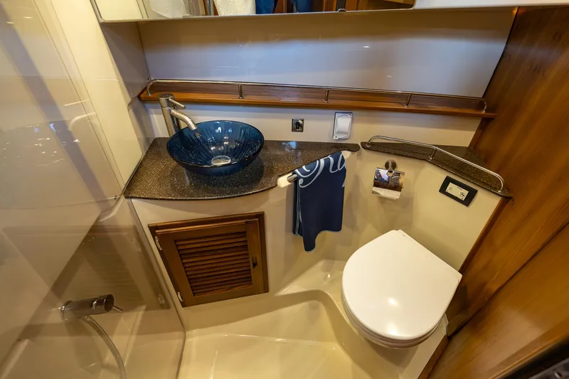 Slide: The Image of 2023 Ranger Tugs R-31 S bathroom with modern sink and toilet. - 26