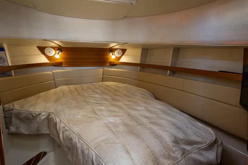 Slide: The Image of 2023 Ranger Tugs R-31 S interior cabin with cozy bed and ambient lighting. - 28