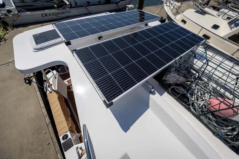Slide: The Image of 2023 Ranger Tugs R-31 S boat with solar panels on deck, docked at marina. - 35