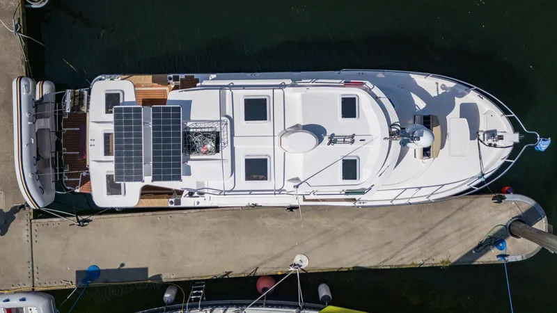 Slide: The Image of 2023 Ranger Tugs R-31 S boat docked, aerial view, featuring solar panels. - 36