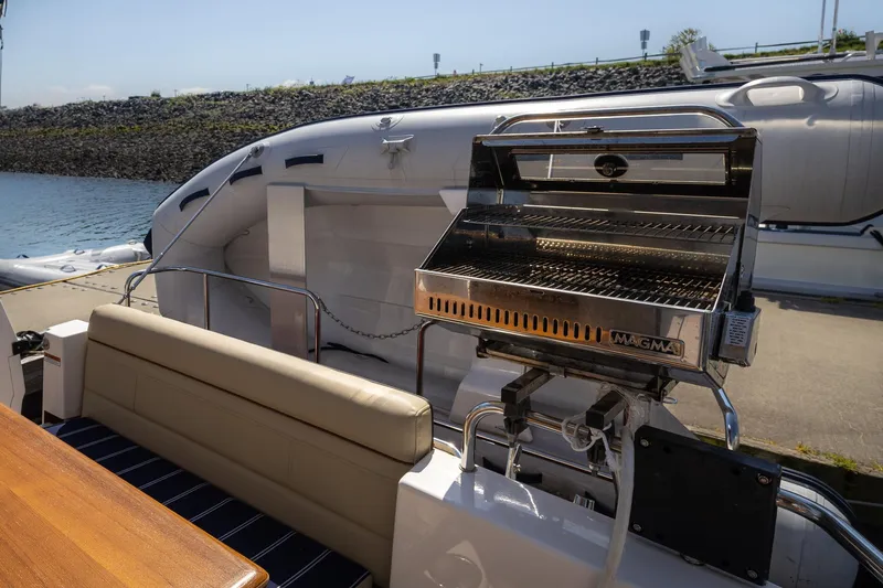 Slide: The Image of 2023 Ranger Tugs R-31 S boat with outdoor grill and seating area. - 4