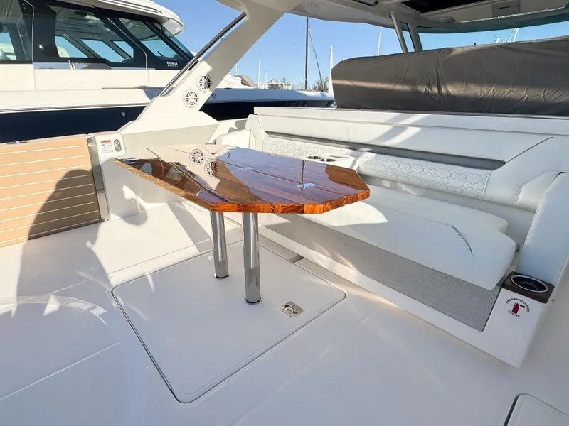 Slide: The Image of Luxurious seating area on 2025 Tiara Yachts 43 LS with elegant wooden table. - 10