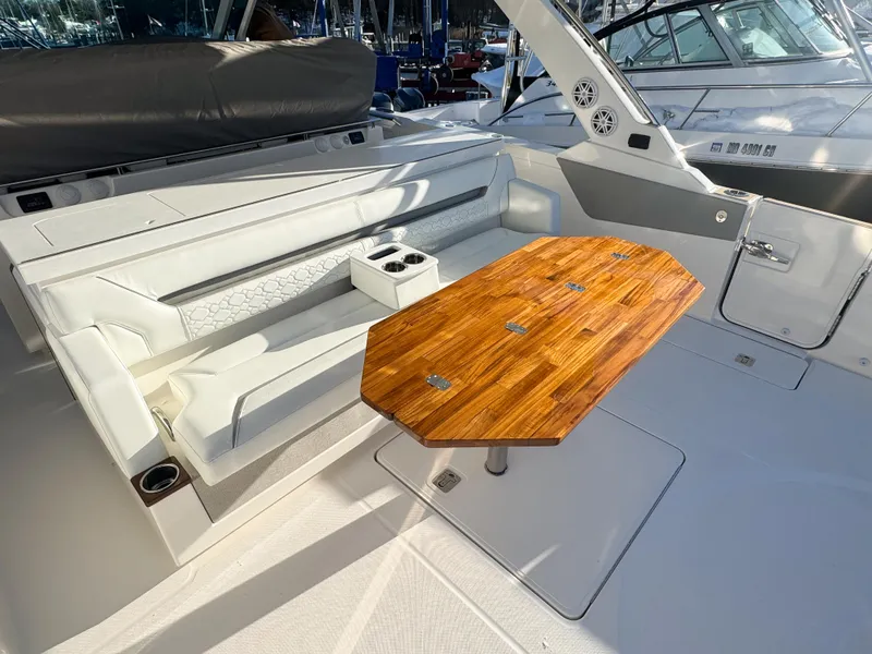 Slide: The Image of 2025 Tiara Yachts 43 LS interior with white seating and wooden table. - 11