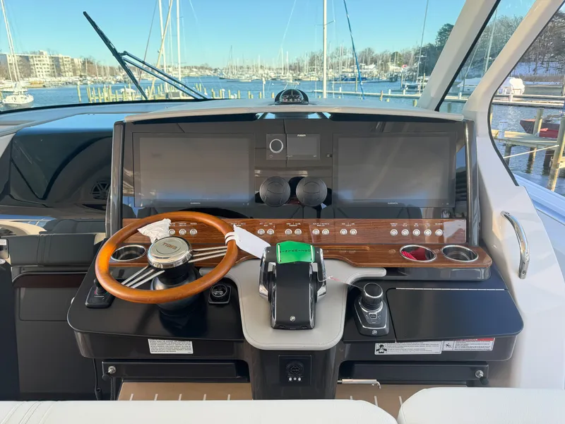 Slide: The Image of Helm of 2025 Tiara Yachts 43 LS with wooden steering wheel and modern controls. - 17