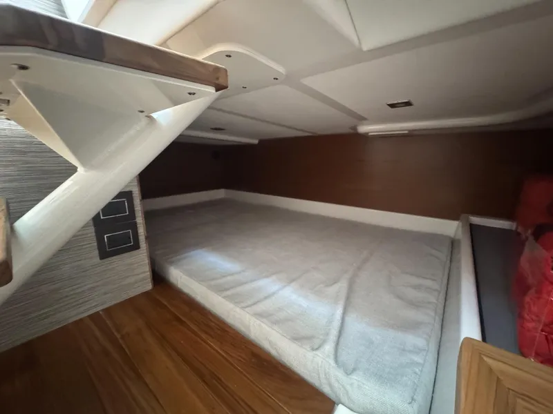 Slide: The Image of 2025 Tiara Yachts 43 LS cabin interior with bed and wooden flooring. - 19