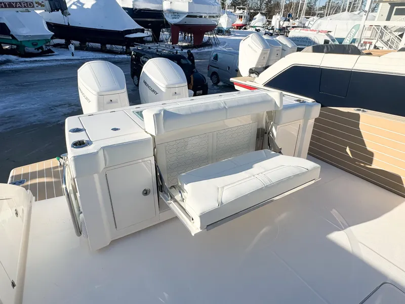 Slide: The Image of 2025 Tiara Yachts 43 LS boat with white seating and powerful outboard engines. - 5