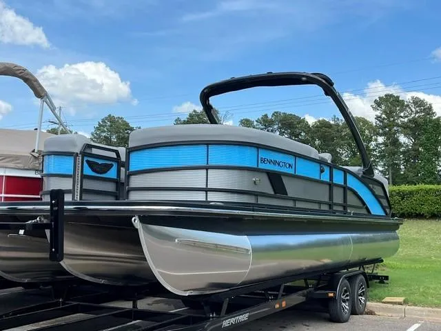 The Image of 2025 Bennington 26 MFB pontoon boat on trailer, featuring sleek design and vibrant blue accents. - 0