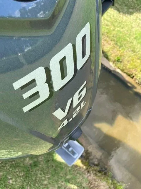 Slide: The Image of Bennington 26 MFB 2025 boat engine, 300 V6 4.2L, near water. - 14