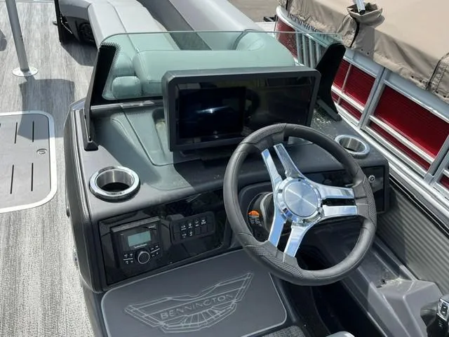 Slide: The Image of 2025 Bennington 26 MFB boat dashboard with steering wheel and digital display. - 4