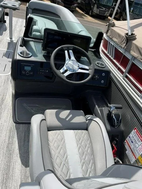 Slide: The Image of 2025 Bennington 26 MFB boat interior with modern steering wheel and dashboard controls. - 6