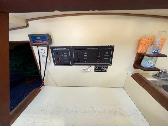 Slide: The Image of Electrical panel and sink area inside a 1983 Pearson 303 sailboat cabin. - 29