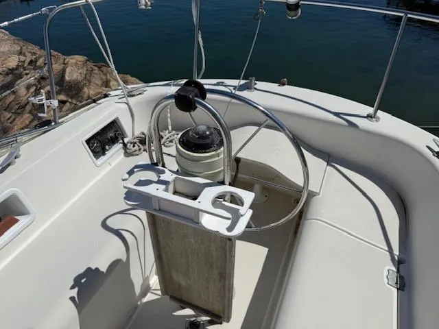 Slide: The Image of Cockpit of 1983 Pearson 303 sailboat with steering wheel and navigation instruments. - 35