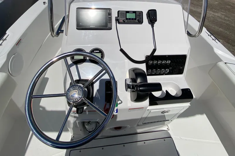 Slide: The Image of 2020 Edgewater 188CC boat console with steering wheel, controls, and navigation equipment. - 12