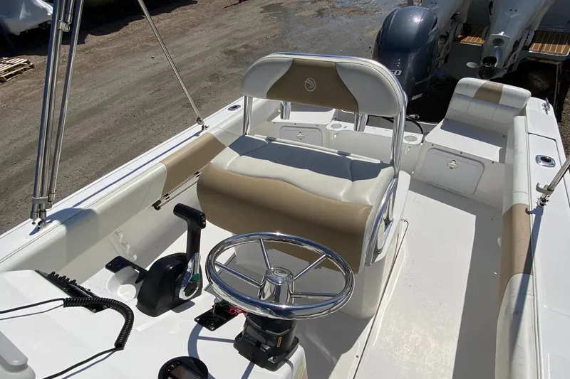 Slide: The Image of 2020 Edgewater 188CC boat interior with steering wheel and seating, showcasing modern design. - 13