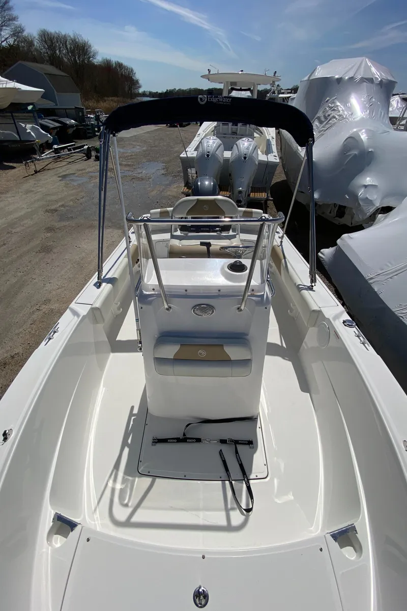 Slide: The Image of 2020 Edgewater 188CC boat with center console, docked outdoors under clear sky. - 17