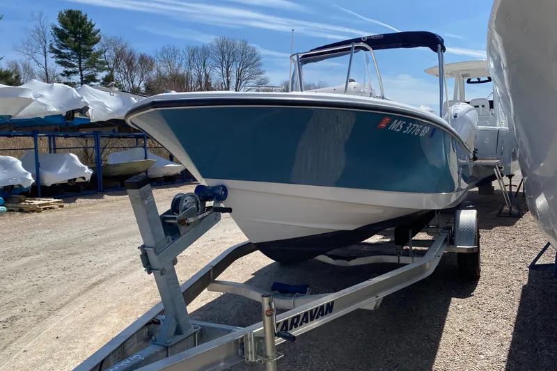 Slide: The Image of 2020 Edgewater 188CC boat on trailer, parked outdoors under clear sky. - 18