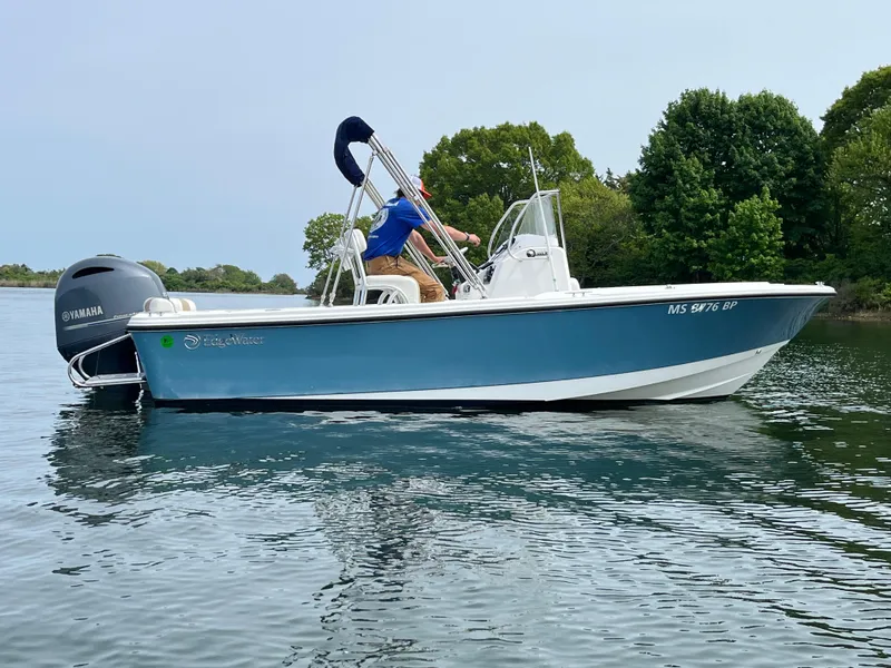Slide: The Image of 2020 Edgewater 188CC boat on calm water with trees in the background. - 2