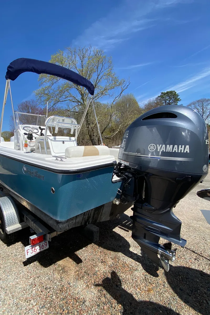 Slide: The Image of 2020 Edgewater 188CC boat with Yamaha outboard motor, parked on a trailer. - 21