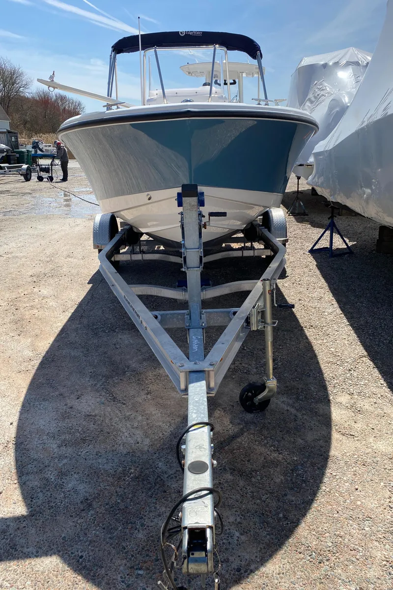 Slide: The Image of 2020 Edgewater 188CC boat on trailer, parked outdoors under clear sky. - 22