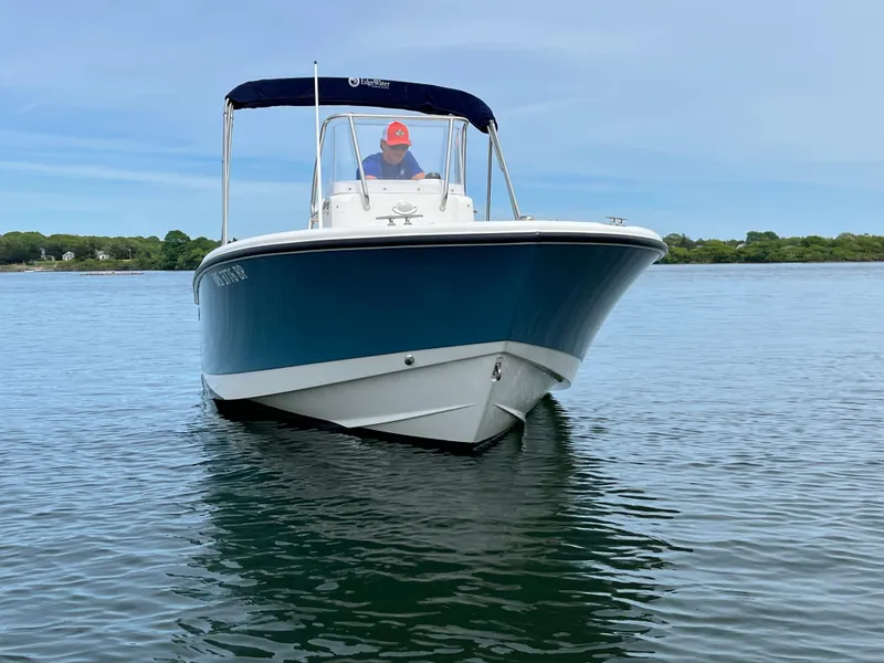 Slide: The Image of 2020 Edgewater 188CC boat on calm water with blue canopy. - 4