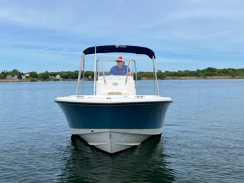 Slide: The Image of 2020 Edgewater 188CC boat on calm water with a person at the helm. - 5