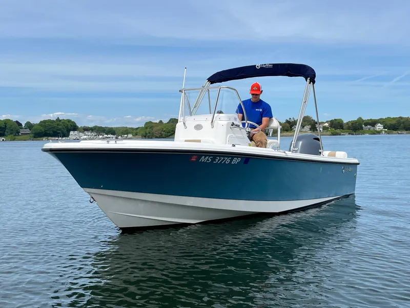 Slide: The Image of 2020 Edgewater 188CC boat on calm water with a person at the helm. - 6