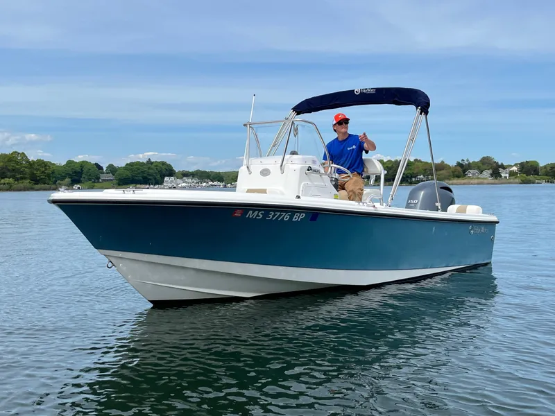 Slide: The Image of 2020 Edgewater 188CC boat on calm water with a person steering. - 7