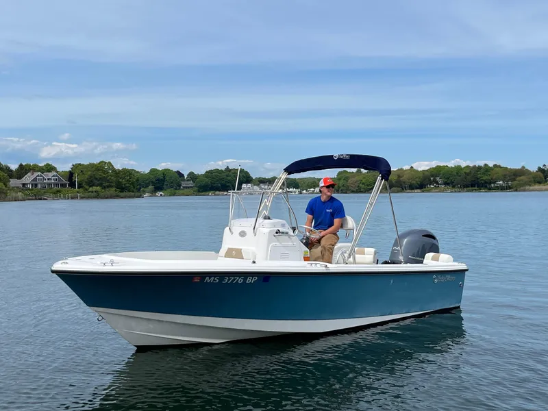 Slide: The Image of 2020 Edgewater 188CC boat on calm water with a person at the helm. - 8