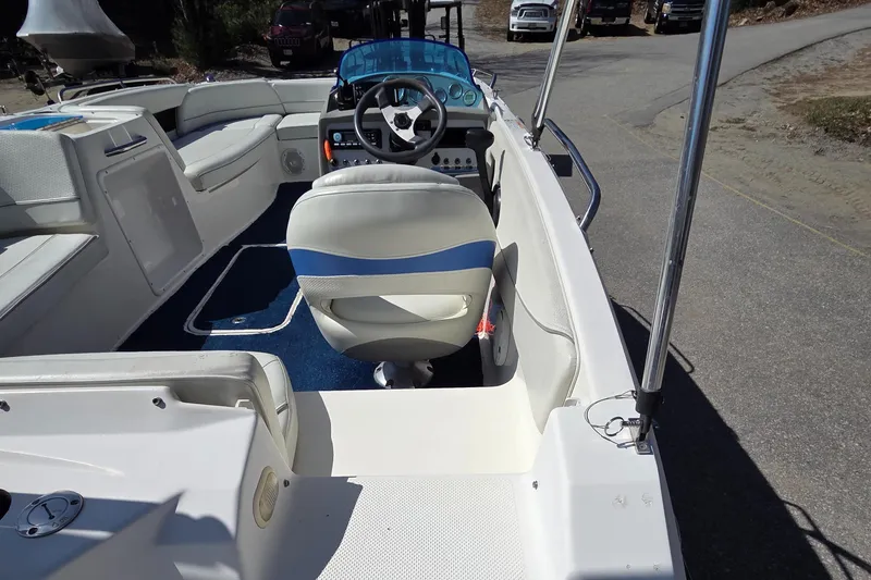 Slide: The Image of 2007 Bayliner 217 Deck Boat interior with steering wheel and seating. - 10